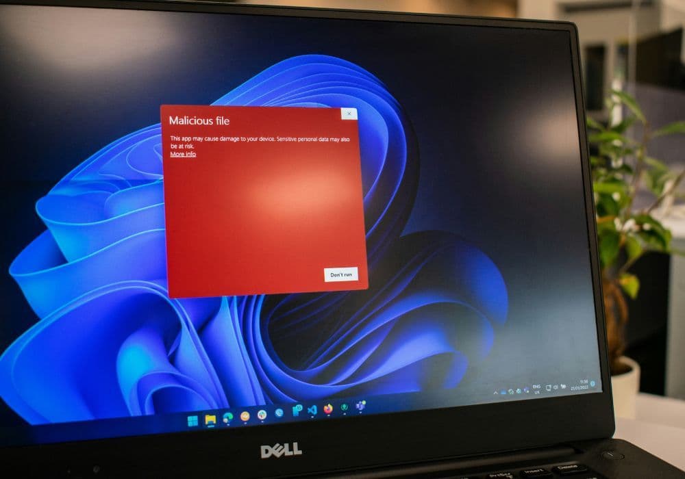 An open laptop displaying a malware warning
